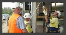 Worker in safety harness at height